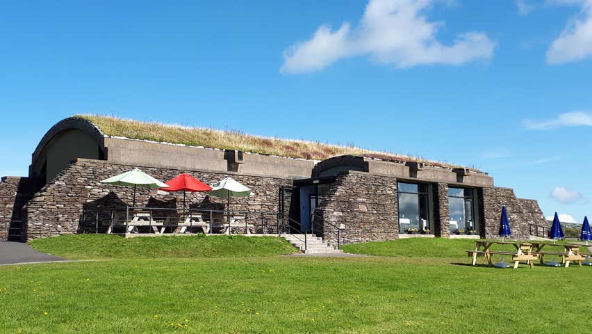 Exterior of Skellig visitor Centre. Blue sky with two clouds. Skellig Michael
