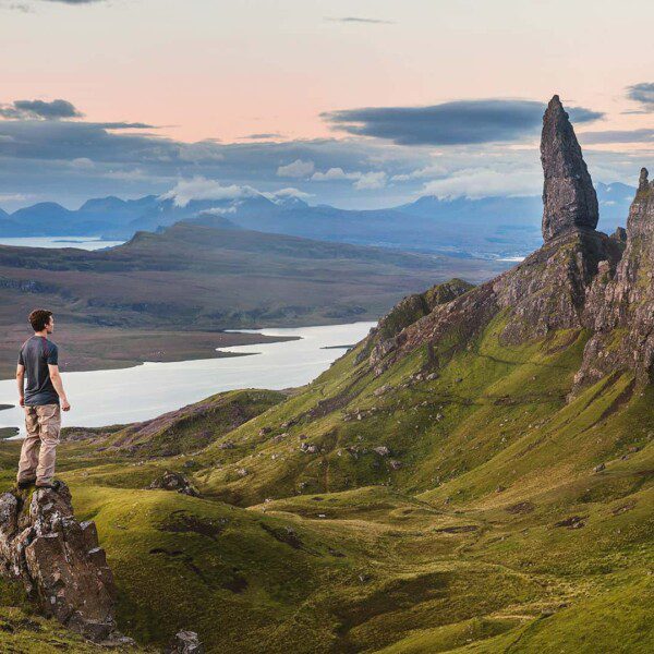 Man Standing on Mountain Peak at isle of Skye - Scotland Tours
