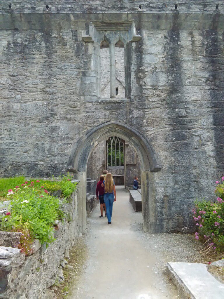 Group entering under Archway at Muckross Abbey Killarney