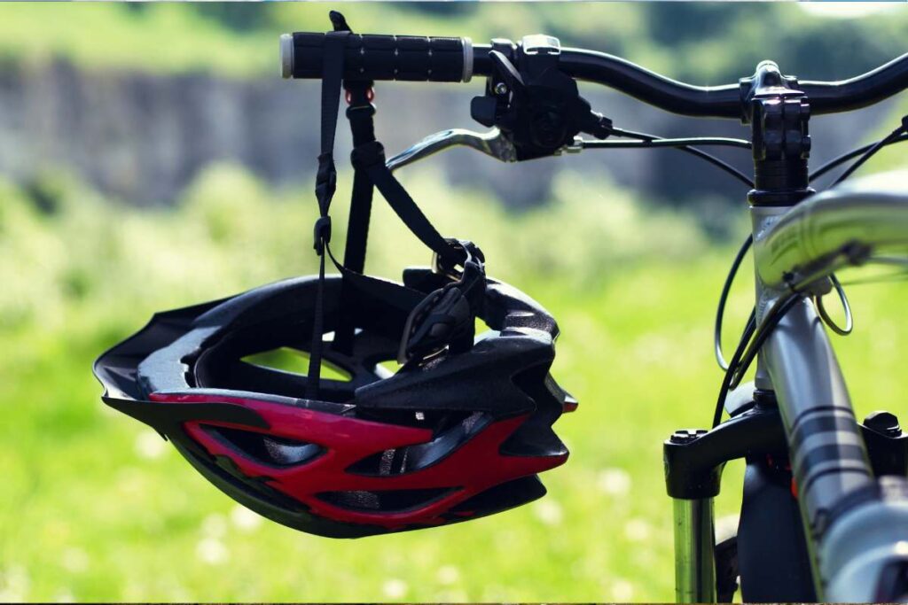 Bike and bicycle helmet in the nature. Close up with bokeh in background