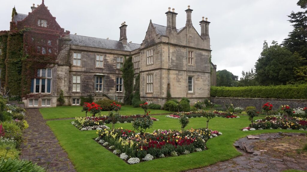 A large stately house, green lawns and flowerbeds. Photo: Chris Carter. Killarney